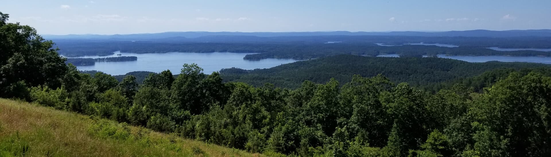 An expansive view of mountains, trees, lakes and rivers